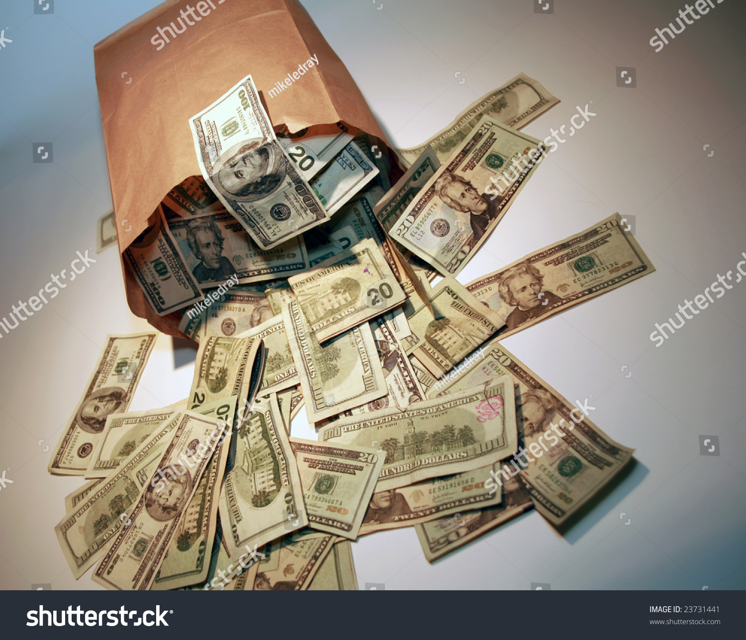 stock-photo-a-generic-brown-paper-bag-over-flowing-with-money-23731441.jpg