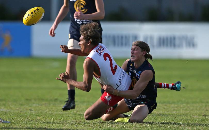 Claremont's Zac Mainwaring lays a tackle on South Fremantle's Darryl Anderson.