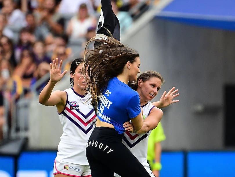 A streaker invades the field and is stopped by Kiara Bowers during the AFLW match between the West Coast Eagles and the Fremantle Dockers.