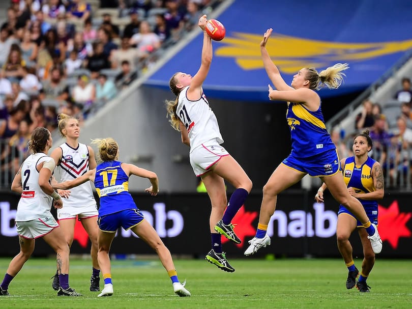 Mim Strom competes in a ruck against Danika Pisconeri during the AFLW match between the West Coast Eagles and the Fremantle Dockers.