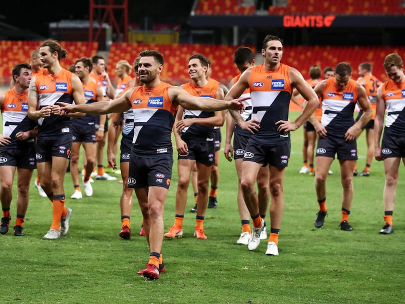 Stephen Coniglio and team mates celebrate winning the round 1 AFL match between the Greater Western Sydney Giants and the Geelong Cats.