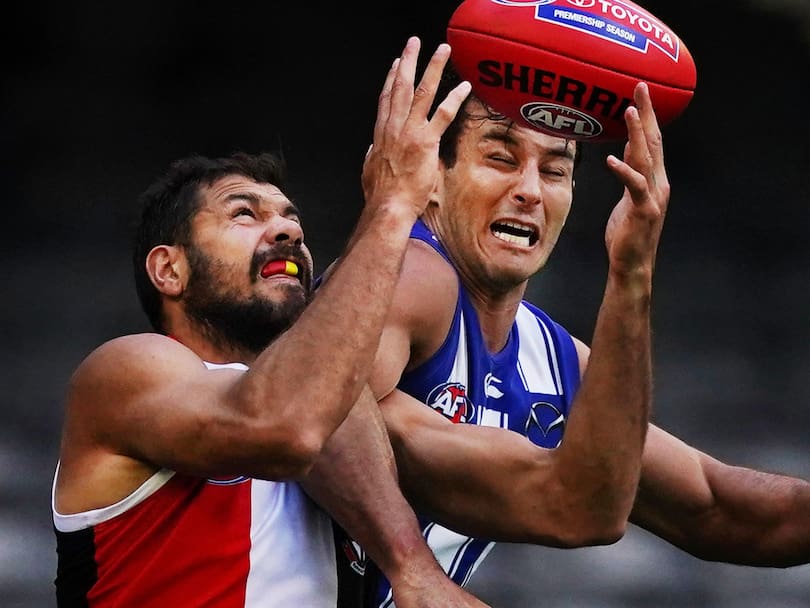 Paddy Ryder of the Saints and Robbie Tarrant of the Kangaroos compete for the ball during the Round 1