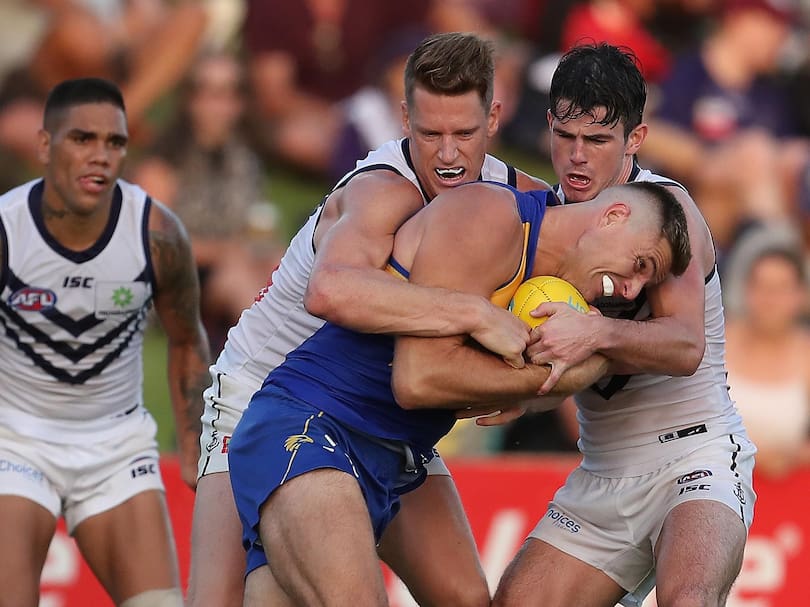 Nathan Vardy of the Eagles gets tackled by Matt Taberner and Andrew Brayshaw of the Dockers.