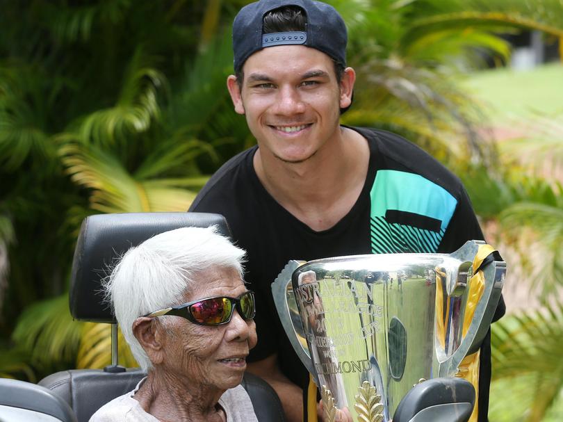 Richmonds Daniel Rioli brings the 2019 Premiership Cup home to Pirlangimpi, his home community on Melville Islandto share with his grandmother.