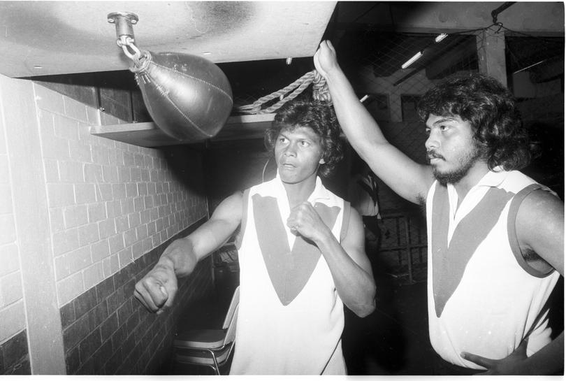 Maurice Rioli watched by brother Sebastian, works out on the punch bag at South Fremantle.