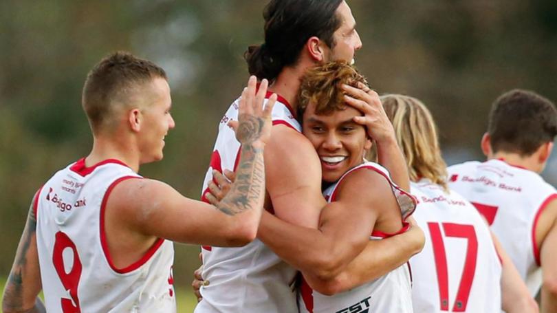 Jesse Motlop celebrates his first senior WAFL goal with teammates.