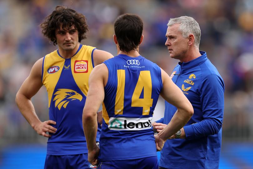 PERTH, AUSTRALIA - MAY 15: Adam Simpson, coach of the Eagles talks with [PLAYERCARD]Tom Barrass[/PLAYERCARD] and [PLAYERCARD]Liam Duggan[/PLAYERCARD] during the round nine AFL match between the West Coast Eagles and the Melbourne Demons at Optus Stadium on May 15, 2022 in Perth, Australia. (Photo by Paul Kane/Getty Images)