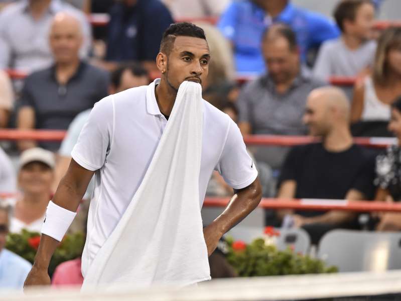 MONTREAL, QC - AUGUST 06:  Nick Kyrgios of Australia holds his towel in his mouth against Kyle Edmund of Great Britain during day 5 of the Rogers Cup at IGA Stadium on August 6, 2019 in Montreal, Quebec, Canada.  (Photo by Minas Panagiotakis/Getty Images)