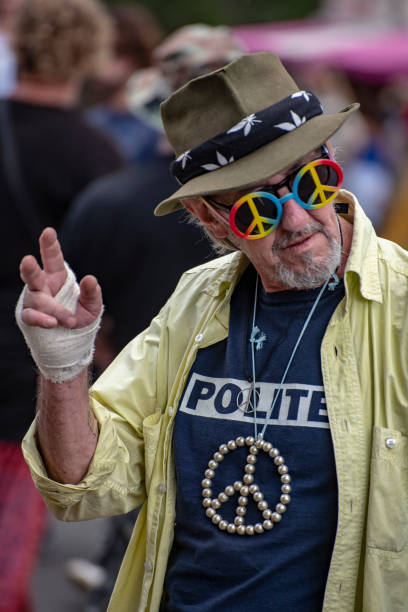 man-wearing-peace-glasses-waves-to-the-crowd-in-the-nimbin-mardi-grass.jpg