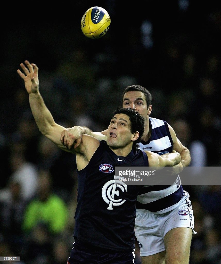 brendan-fevola-of-the-blues-is-held-by-matthew-scarlett-of-the-cats-picture-id71396371