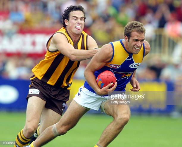 nathan-lonie-of-hawthorn-chases-chris-judd-of-the-eagles-during-the-picture-id1900557