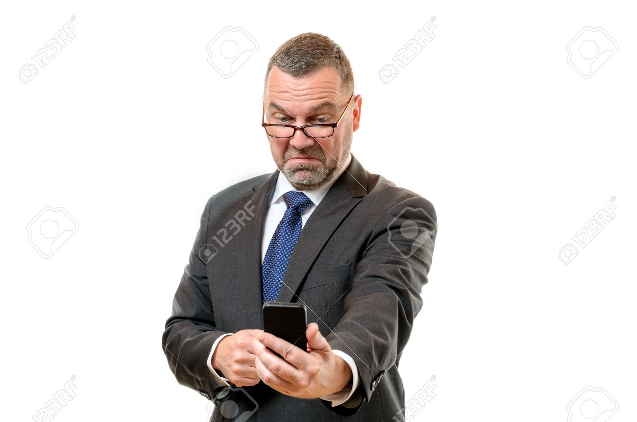 57184310-businessman-pulling-disdainful-face-of-disgust-as-he-reads-a-message-on-his-mobile-phone-held-at-arm.jpg