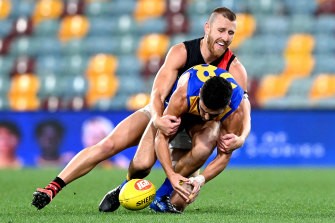 Dyson Heppell tackles West Coast’s [PLAYERCARD]Tom Cole[/PLAYERCARD] in one of just three matches the Essendon captain played in 2020. 