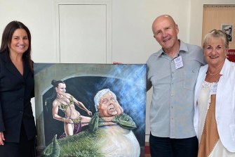 Senator Jacqui Lambie in her office with the Bald Archy portrait depicting her as Princess Leia and Clive Palmer as Jabba the Hutt, which was dropped off by owners Ray and Elain.