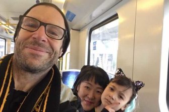 Tigers fan Kevin Passmore, his partner Jin ah Jo and daughter Ara on their way to the 2019 grand final. 