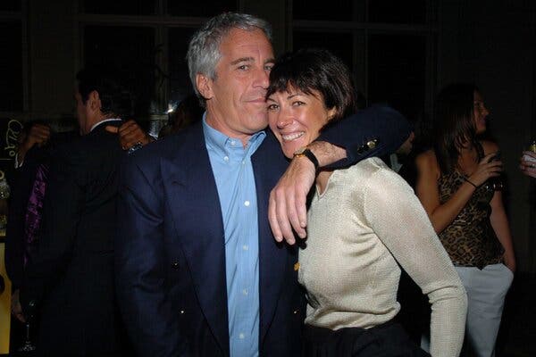 Jeffrey Epstein and Ghislaine Maxwell standing next to each other at what appears to be a party. Mr. Epstein has his left arm around Ms. Maxwell’s shoulders and his left cheek pressed against the side of her head. She grins widely.