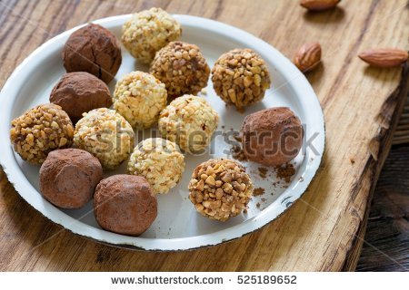 stock-photo-chocolate-truffle-balls-with-nuts-on-a-plate-525189652.jpg