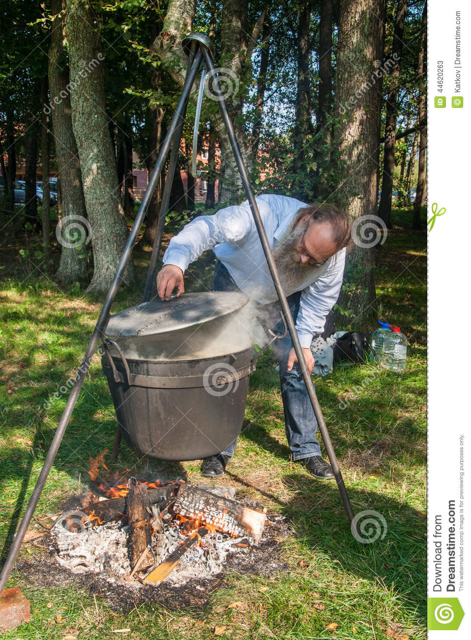 skilful-cook-prepares-soup-over-fire-cooking-hike-cauldron-hanging-44620263.jpg